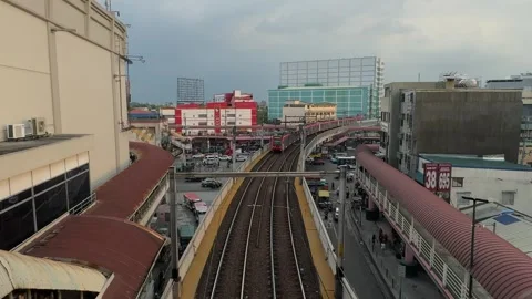 LRT train arriving at Pasay Taft Avenue station under cloudy sky 4K Stock Footage 337458716