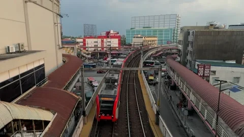 LRT train moving at Pasay Taft Avenue station under cloudy sky 4K Vídeos de archivo 337458713