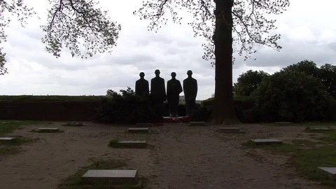LS Four Statues of Soldiers in Shadow at Langemark German War Cemetery Stock Footage 98033207