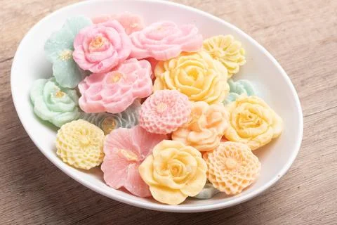 A-lua or Allure Thai handmade candy in a mini bowl on gray desktop. A-lua T.. Foto stock