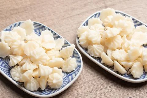 A-lua or Allure Thai handmade candy in a mini bowl on gray desktop. A-lua T.. Stock Photos