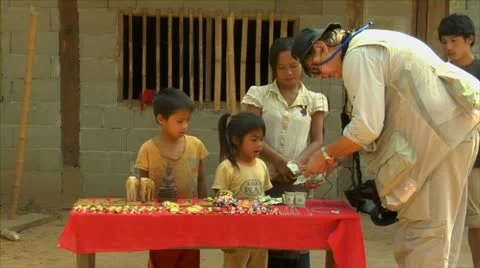 Luang phabang laos lao tourist buying souvenirs from mother and children in s Stock Footage