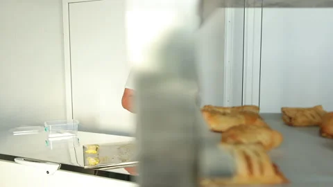 Lubricate with a brush prepared mixture of raw dough for making buns, cookies. Stock-Footage 140962288