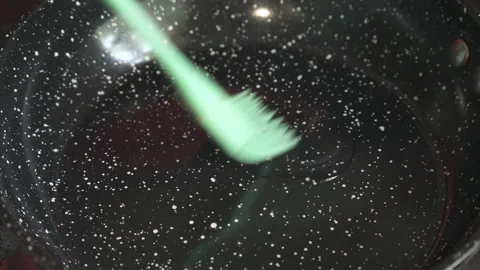 Lubricate the surface of the pan with oil using a silicone brush. Video stock 195097725