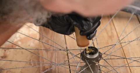 Lubricating ball bearing using lithium grease, close-up Stock Footage 159731928