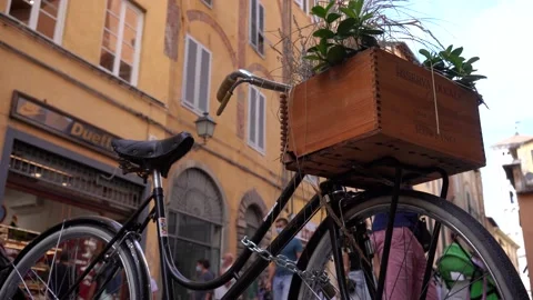 Lucca,bicycle in the foreground, in the background people walking with masks Stock Footage 138463094