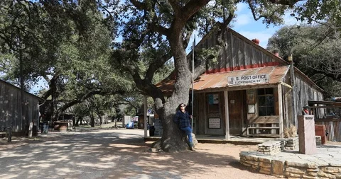 Luckenbach Texas historic Post Office town woman by tree 4K Видео 103127101