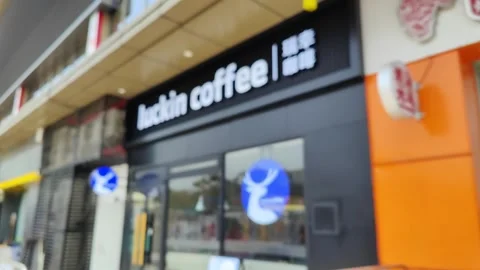 Luckin coffees from out-of-focus blur to clear focus in a shopping mall Stock Footage 306223411