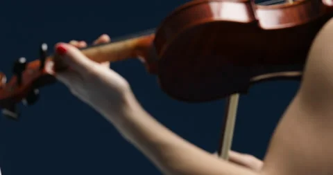 Lue backdrop frames violinist's detailed performance journey Stock Footage 253449737