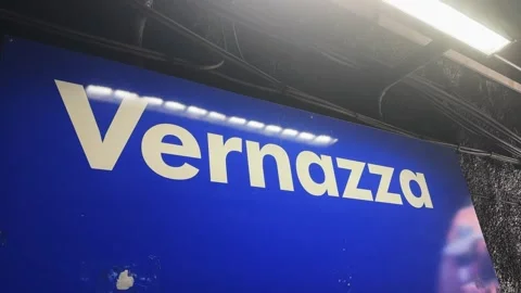 Lue train station sign displaying 'Vernazza', located in the iconic village o Stock Footage 345151487