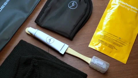 Lufthansa in-flight amenity kit for passenger comfort Stock Footage 325761789