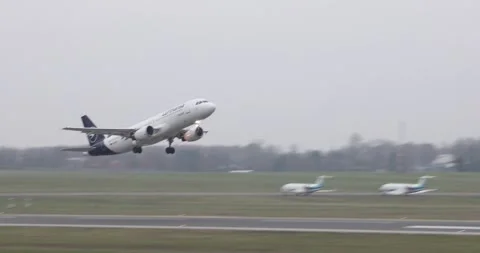 Lufthansa jet taking off from runway on grey overcast day Stock Footage 321049858