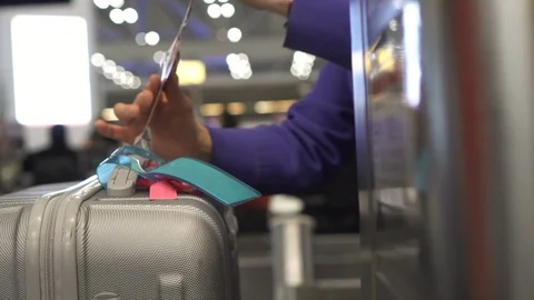 Luggage check in tag attach before loading Stock Footage 104290667