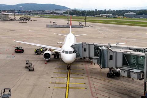 Luggage loading of plane docked at gate, Airport Zurich, Switzerland 09052024 Stock Photos
