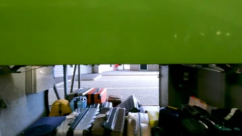 Luggage storage compartment trunk of Green Flixbus with passengers boarding Stock Footage 245750254