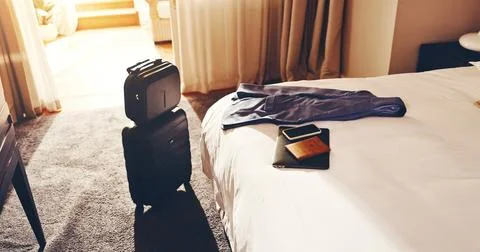 Luggage, tech and passport in empty hotel room for business trip, internati.. Stock Photos