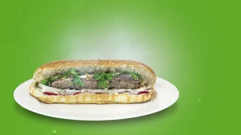 Lule kebab in bread on green background direction from left to center Stock Footage 135126247