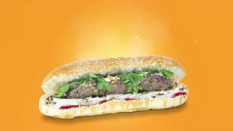 Lule kebab in bread on orange background position from right to center Stock Footage 135073334