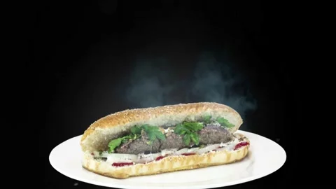 Lule kebab in bread on white plate the served with greens, onions, mayonnaise Stock Footage 134471044