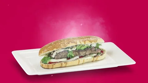 Lule kebab in bread on white plate on purple background Stock Footage 135153613