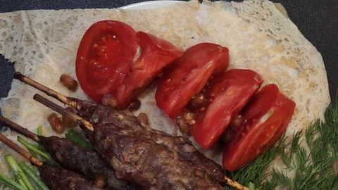 Lule kebabs on a plate overhead Stock Footage 103984816
