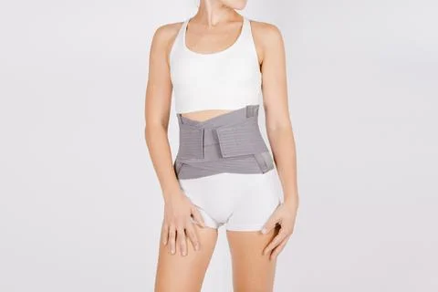 Lumbar brace on the human body isolated on a white background. Trauma of back Stock Photos