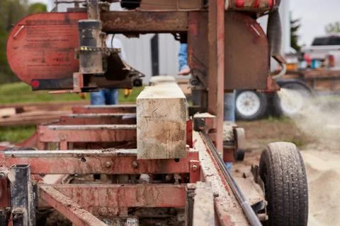 Lumber being cut and processed at a sawmill Stock Photos