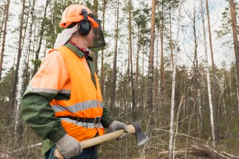 Lumberjack with an axe on the forest background Stock Photos