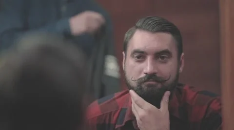 Lumberjack bearded man looking to mirror barbershop HD slow motion video Stock Footage 68378247