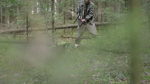 Lumberjack is chopping dry fallen tree Stock Footage 75472298