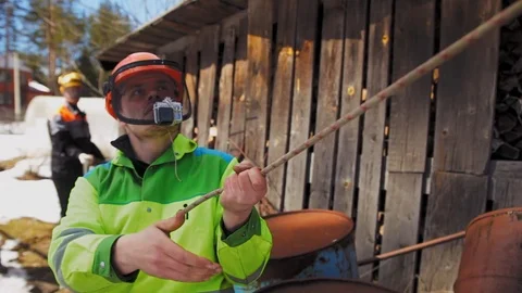 Lumberjack connects the system for Felling the tree together Stock Footage 97409679