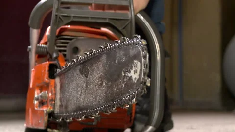 A lumberjack gets a chainsaw to work. Chainsaw, Saw Stock Footage 97987622