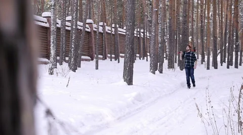 Lumberjack with his ax returns from work of the winter forest Stock Footage 60050757