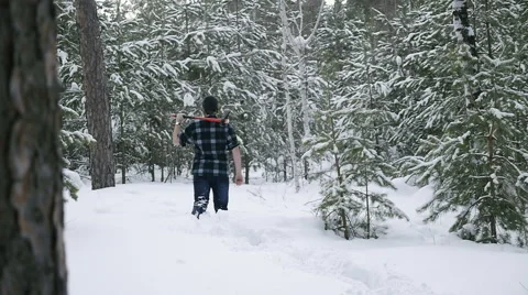 Lumberjack with his ax returns from work of the winter forest Video stock 60050856