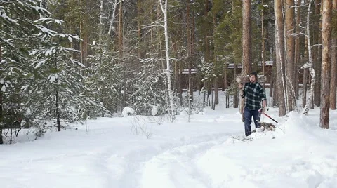 Lumberjack with his ax returns from work of the winter forest Stock Footage 60057658