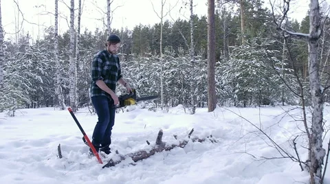 Lumberjack tries to start manual chainsaw Stock Footage 60055847