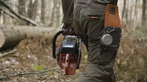 Lumberjack is walking with chainsaw 動画素材 92890679