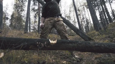 Lumberjack worker standing in the forest with axe and chainsaw Stock Footage 81171880