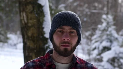 The Lumberjack working in a snow forest. A portrait handsome young man Stock Footage 149053320