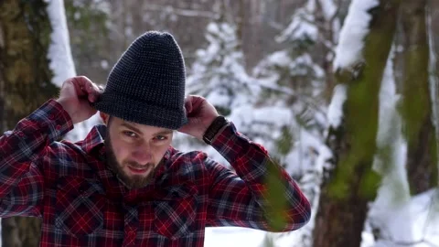 The Lumberjack working in a snow forest. A portrait handsome young man Stock Footage 149053836