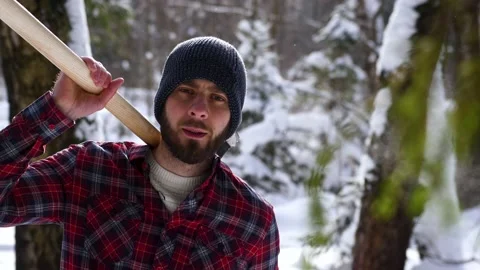 The Lumberjack working in a snow forest. A portrait handsome young man Stock Footage 149054060