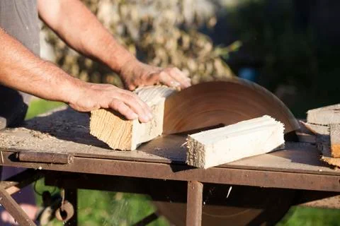 Lumberman working on circular saw Stock Photos
