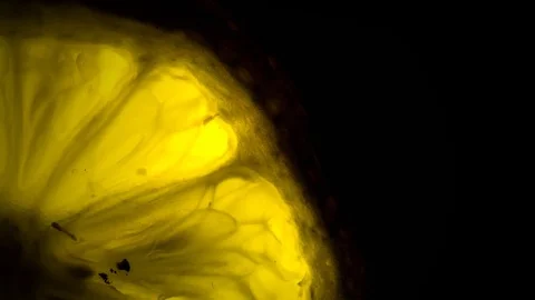 Luminescent lemon on black background Stock Footage 79733188