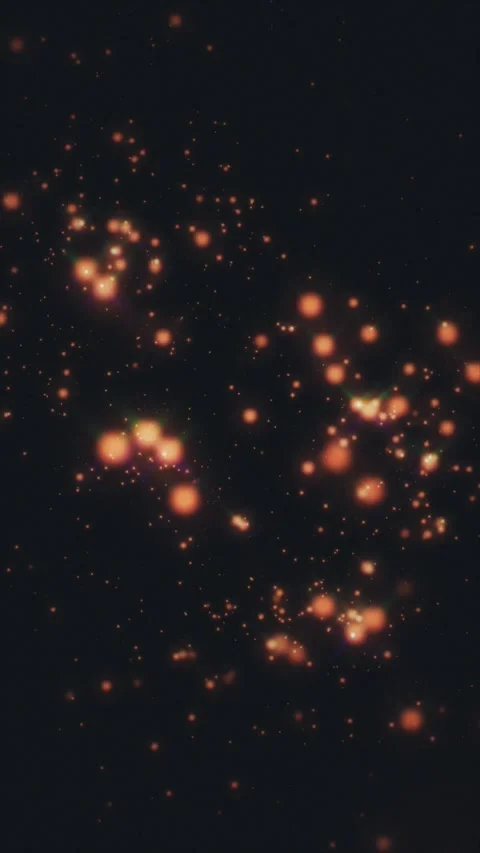 Luminous amber dots softly glow and drift across the dark expanse Stockbeeldmateriaal 333099362