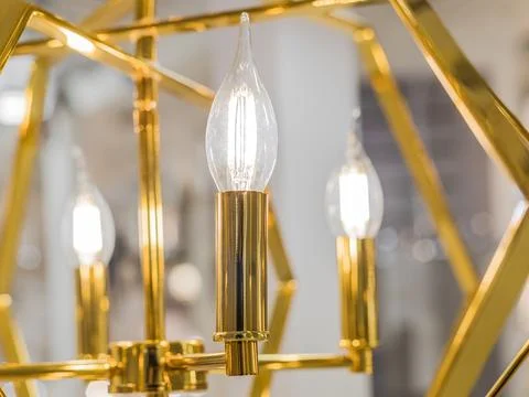 Luminous ceiling shade made of yellow gold metal with transparent glass lamps Stock Photos