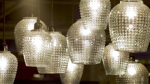 Luminous chandeliers swing from the ceiling. slow motion Stock Footage 102360969