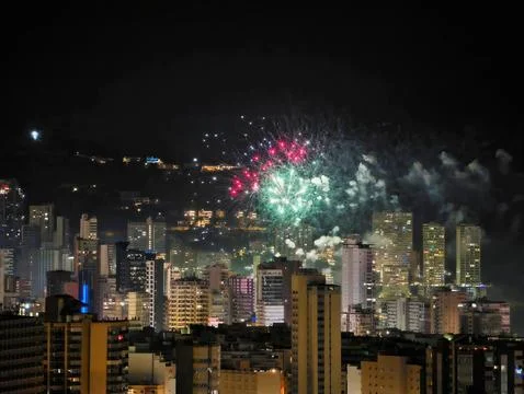 Luminous Display Of Pink And Green Fireworks Accentuates Romantic Rooftop Stock Photos
