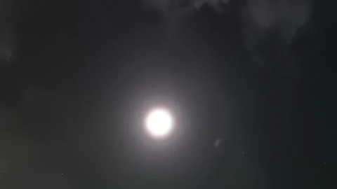 A luminous full moon glows brightly in the night sky 스톡 동영상 340630088