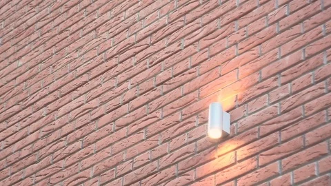 Luminous lantern on a red brick wall of a building on the street Stock Footage 77575921