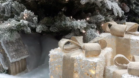Luminous lanterns in the form of gifts under the Christmas tree in 4K Stock Footage 117169809